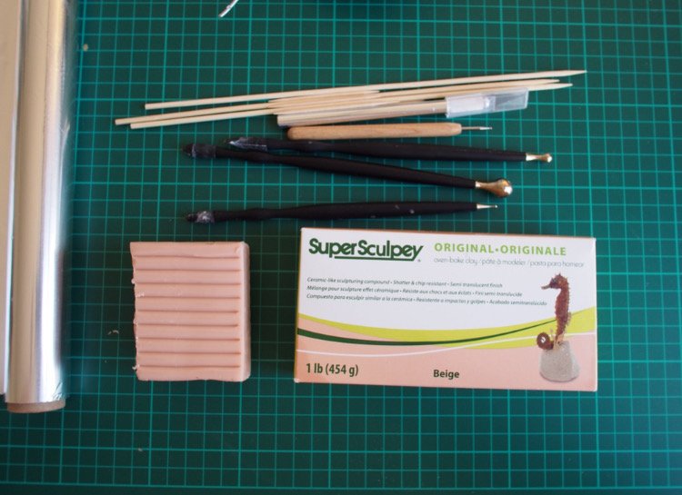 Tin foil base with wire armature for limbs, and covered in Super Sculpey