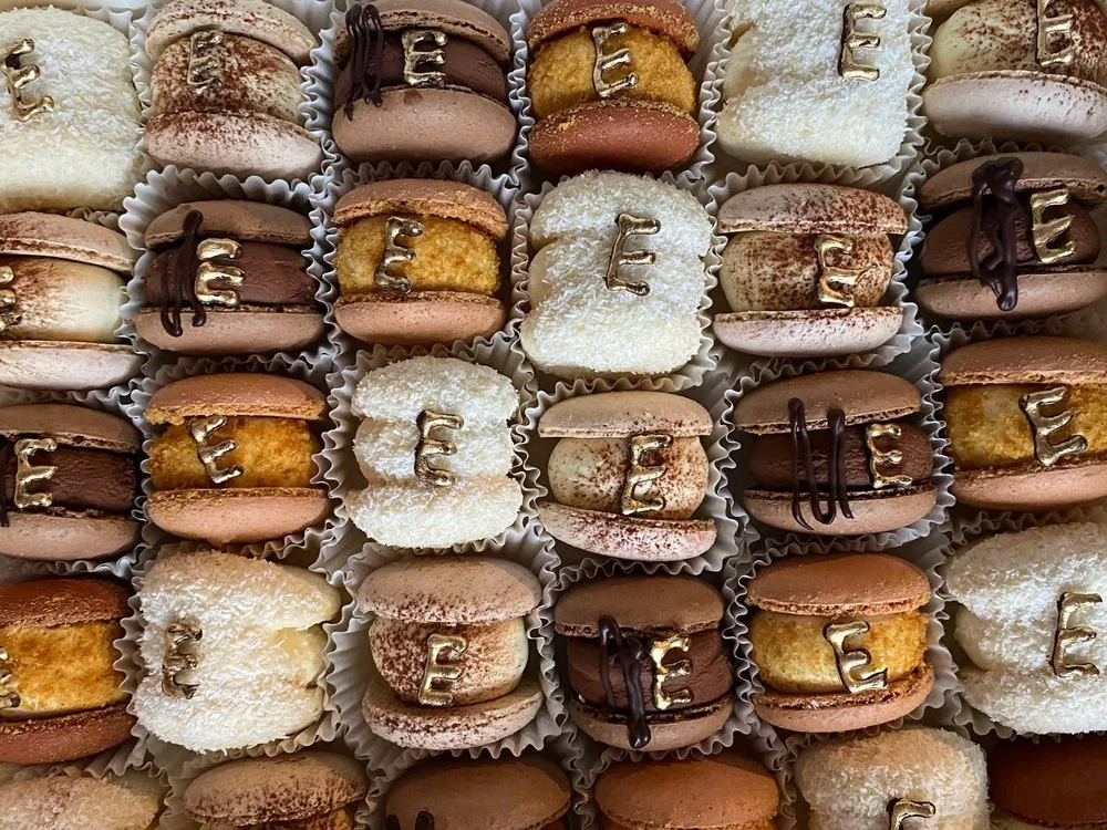 Macarons decorated with a gold letter E for the Eddy's store opening