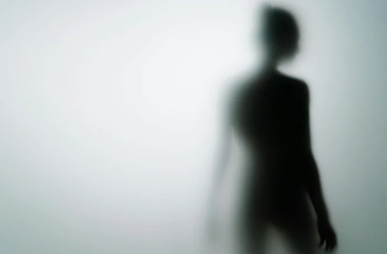 Woman in black shadow as if it’s hiding - The Orthodox Therapist.jpg