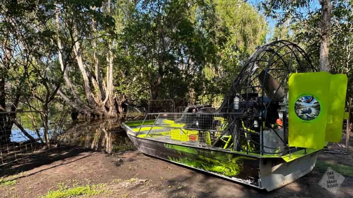 NT Airboats airboat seen from the side, showing the large fan propeller and green livery at the Darwin wetlands