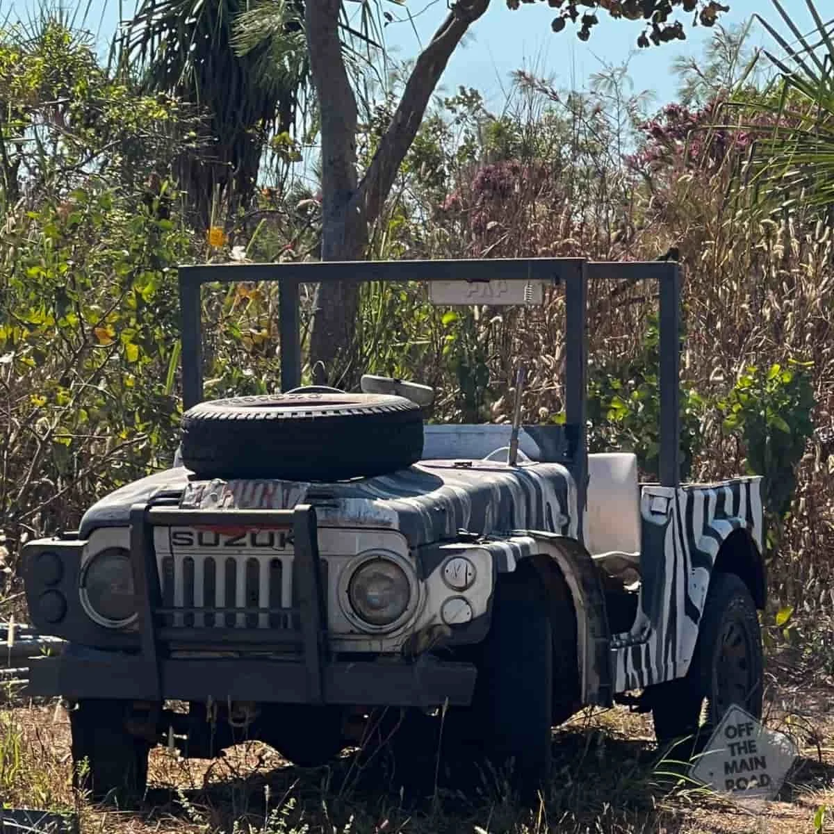 Vintage military Suzuki jeep parked beside paperbarks at the Northern Territory Airboats base near Darwin