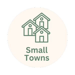 Illustration of three small houses with the text 'Small Towns' underneath, all inside a circular white background.