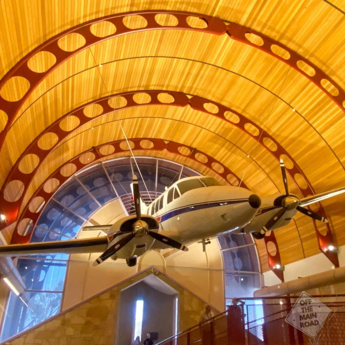 RFDS Beechcraft Queen Air suspended beneath the curved timber roof inside the Australian Stockman's Hall of Fame, Longreach