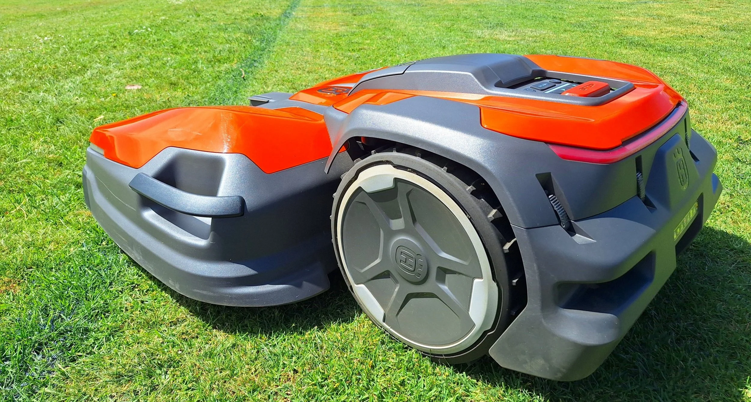 A robotic lawn mower on a grassy lawn