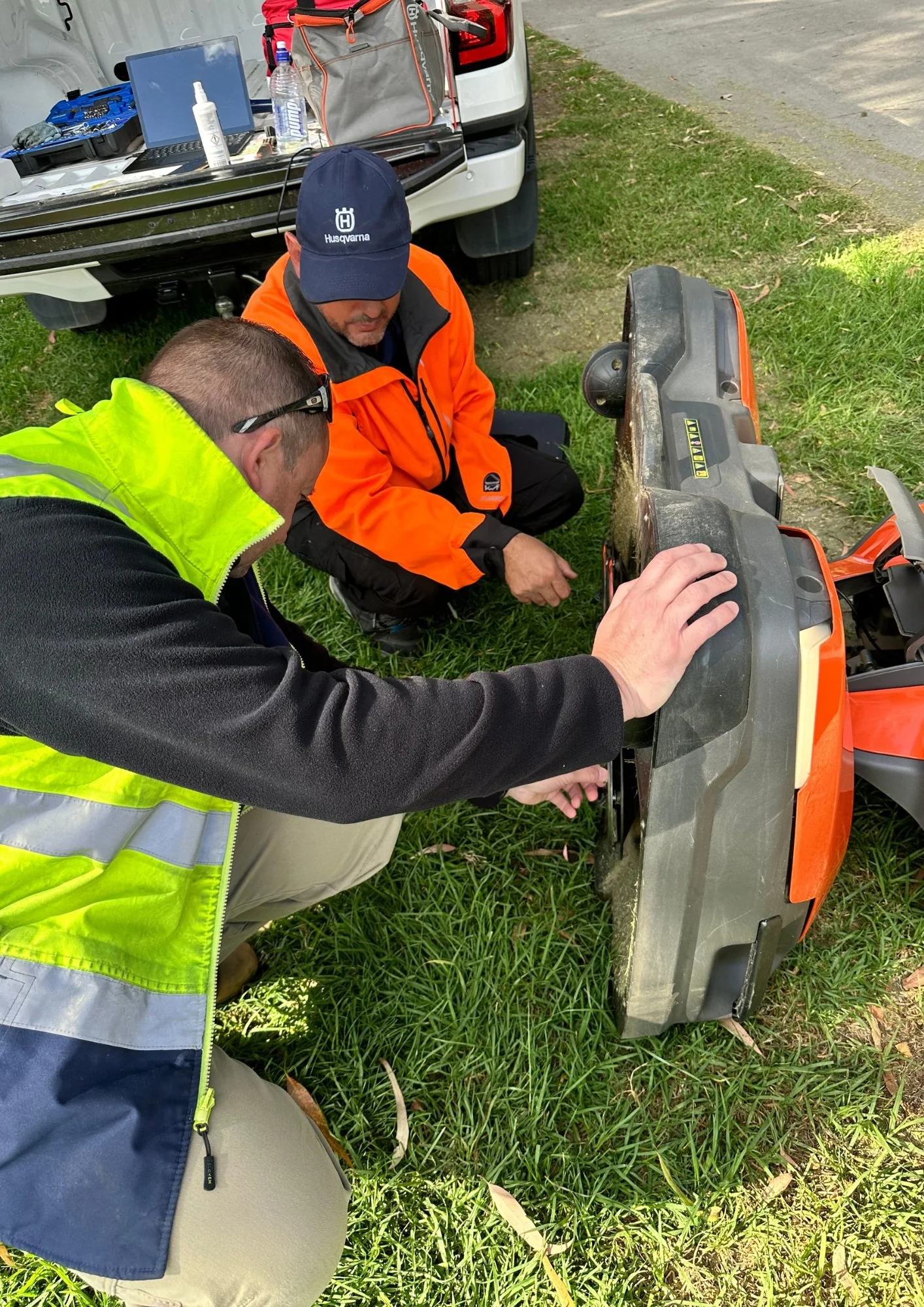 Technician performing Husqvarna Automower service check