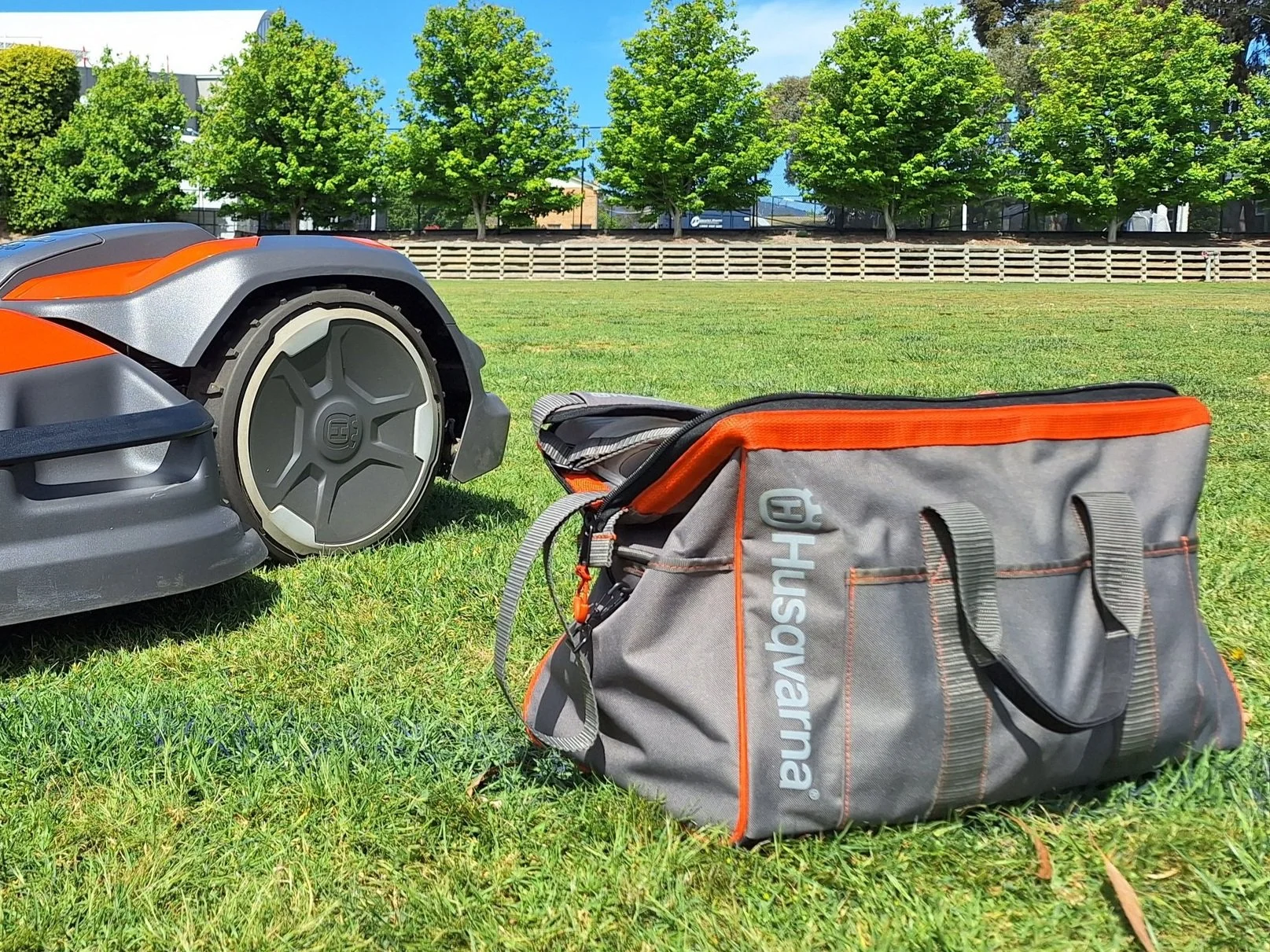 Certified Husqvarna technician repairing robotic mower electronics
