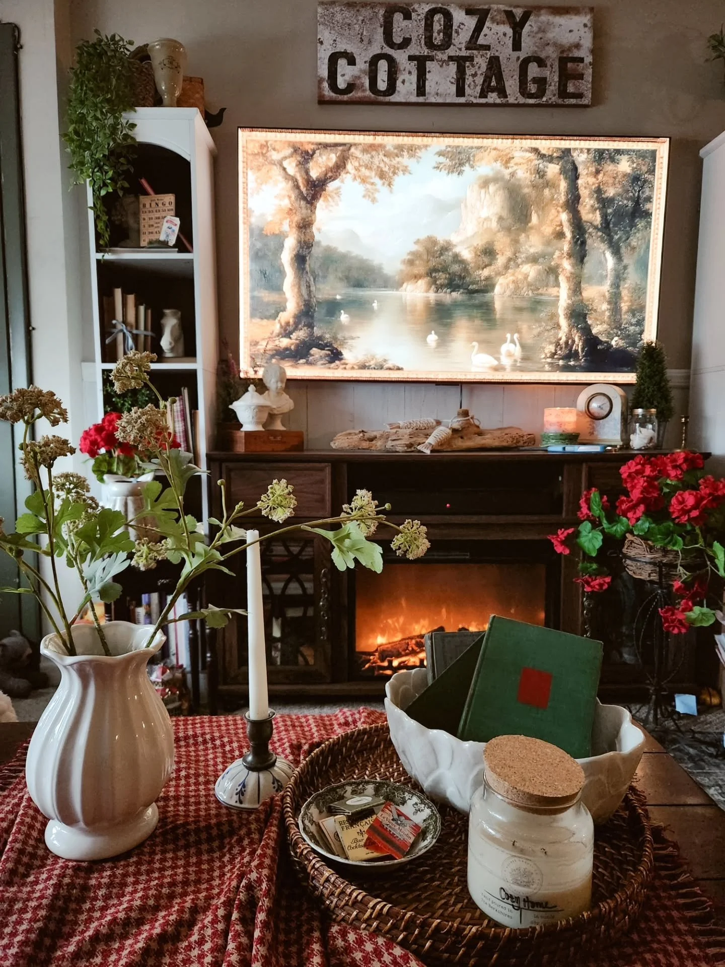 Not decorating for fall yet&hellip; just craving warmth, richer colors, and a home that feels a little extra cozy lately 🤎

What&rsquo;s your favorite detail here: the fire, the florals, the old books, or the red check tablecloth?