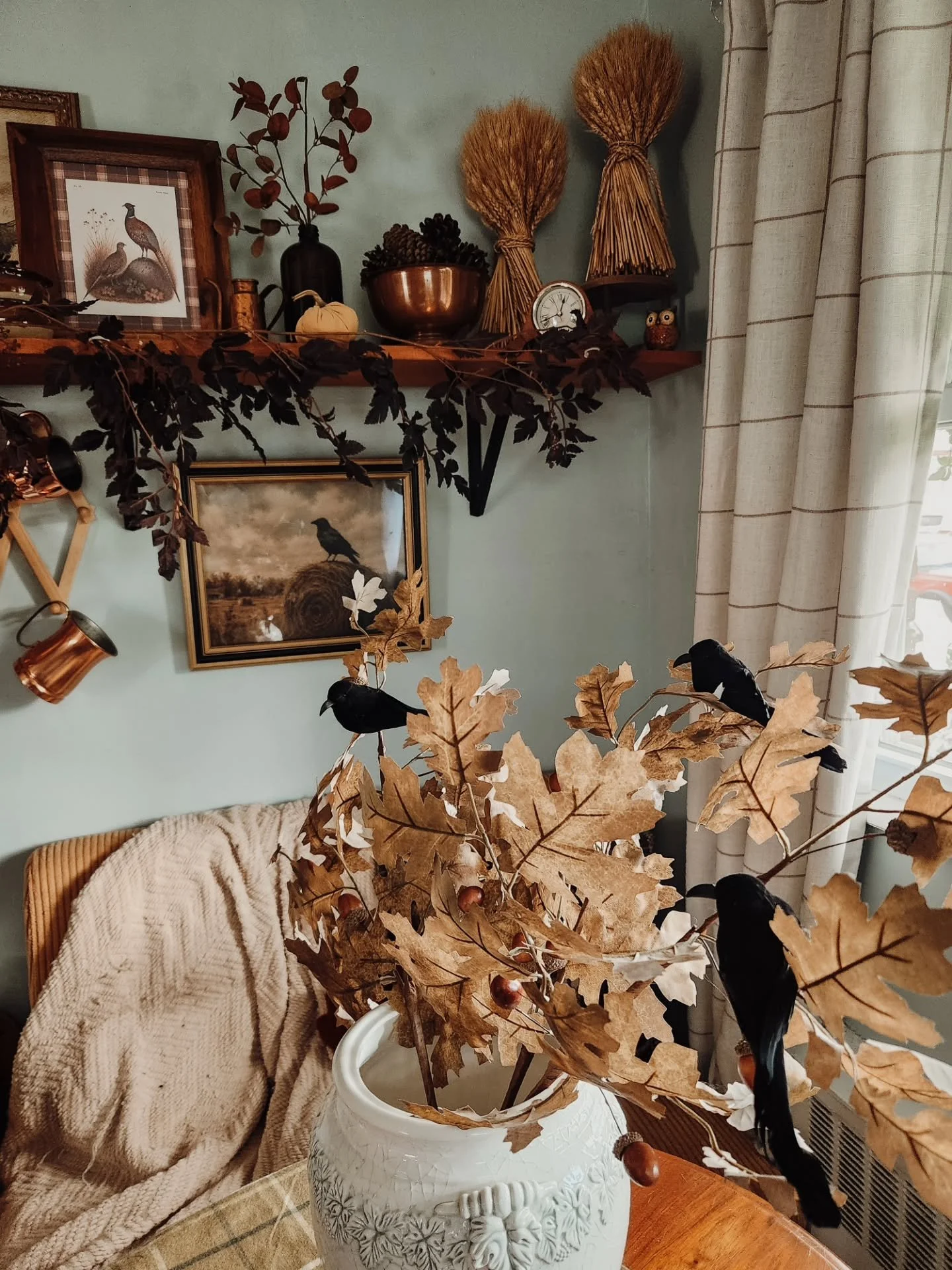 I fear the crows are no longer decorations. They live here now. 🖤

They&rsquo;ve claimed the shelves, settled into the branches and made themselves very comfortable among the old copper, dried leaves and autumn treasures. Honestly, I think this kitc