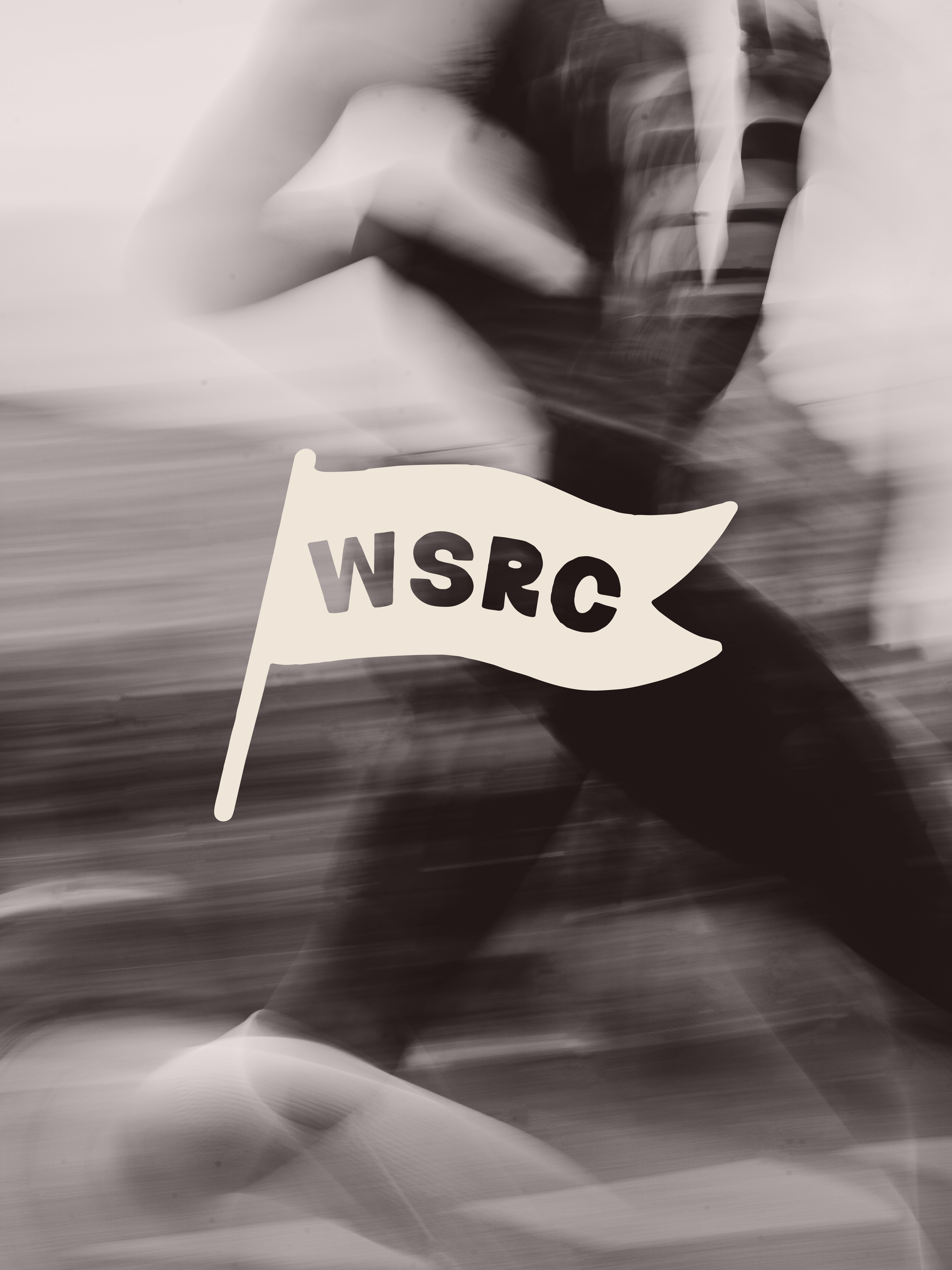 A person holding a small flag with the text "WSRC" on it, in black and white, with motion blur.