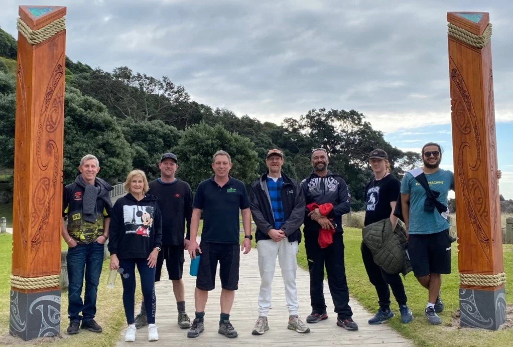 Laminated Beams team between a traditional carved timber sculptures at Mount Maunganui | Mauao