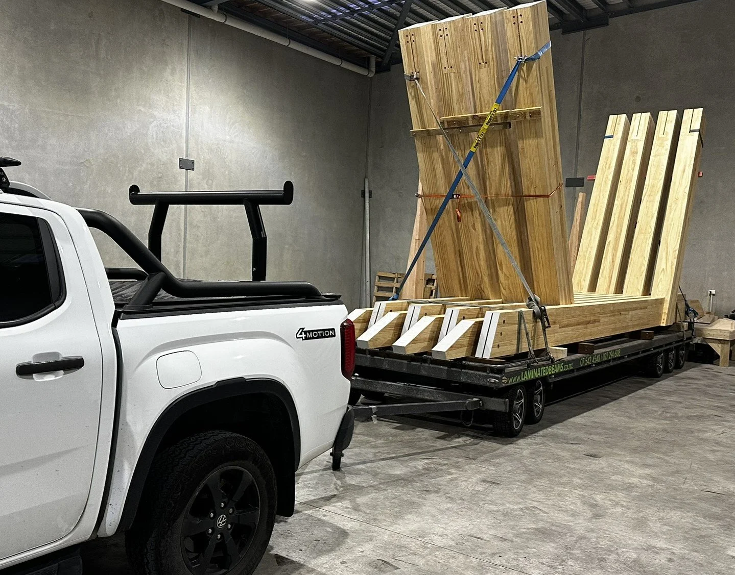 Glulam timber portals loaded on a trailer ready for delivery.