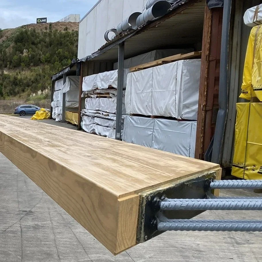 Close-up of metal and rebar joinery on a glulam timber beam.