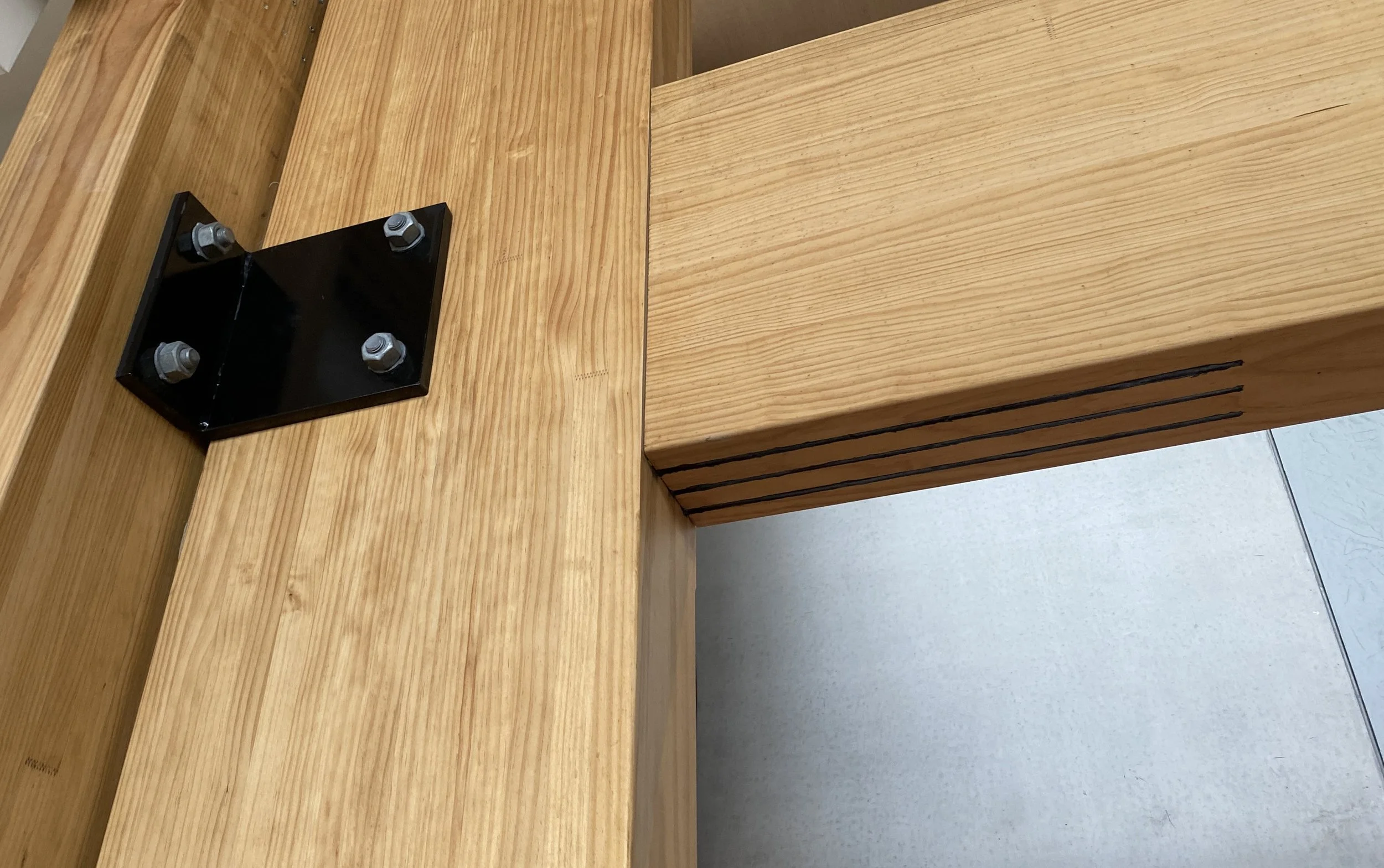 Close-up of a glulam timber beam with joinery.