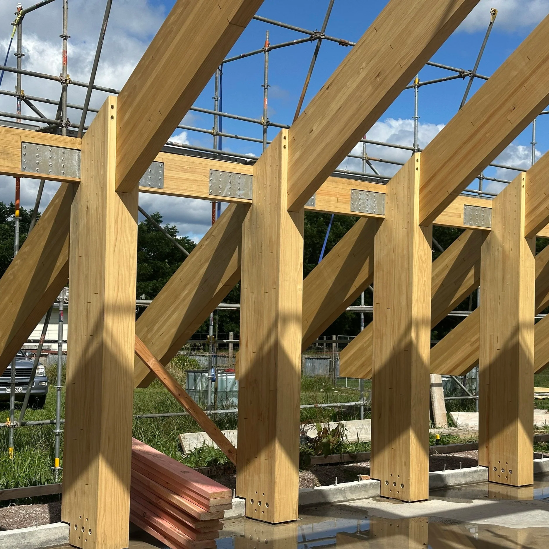 Glulam timber beams framing for a building under construction.