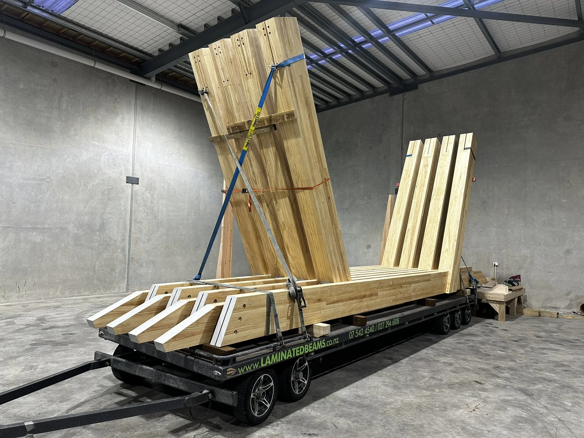 Large glulam timber portals pre-assembled and ready for delivery to site