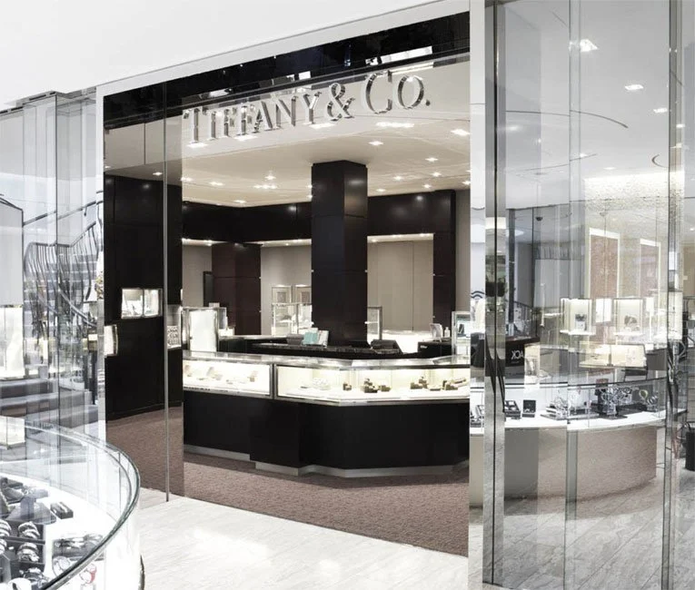 Tiffany & Co. jewelry store display with glass cases showcasing jewelry inside a mall.