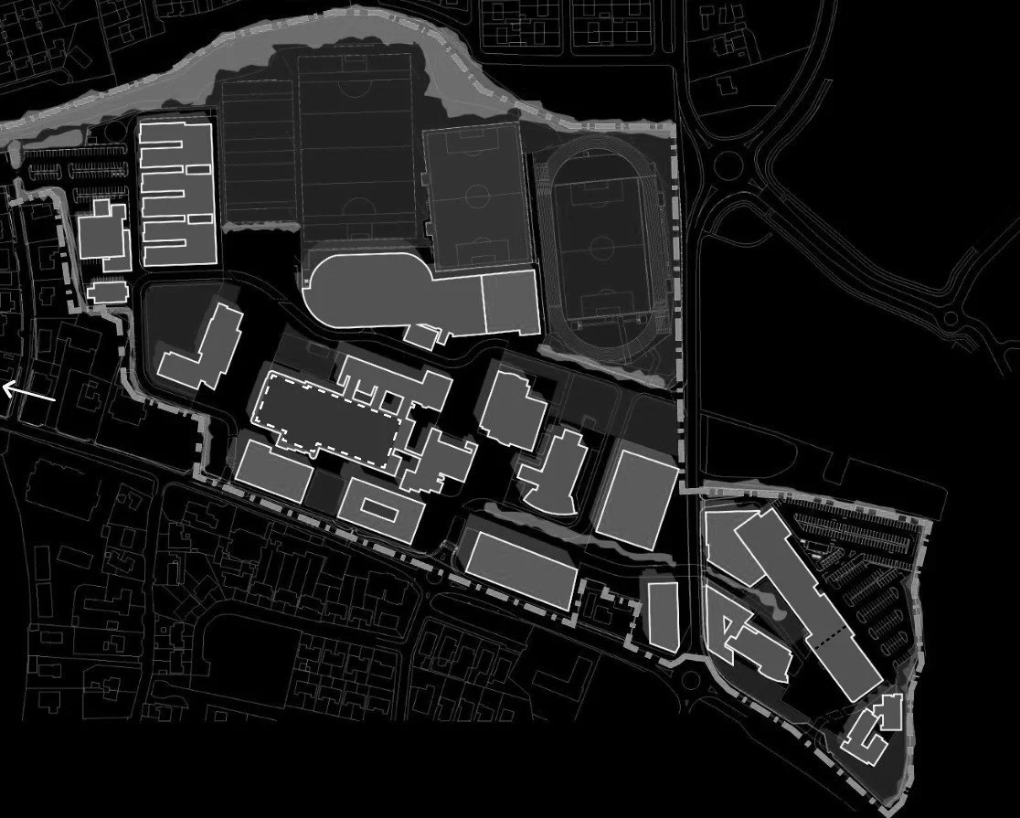 A black and white site plan of a sports complex and surrounding buildings, including soccer fields, a track, parking lots, and various structures.