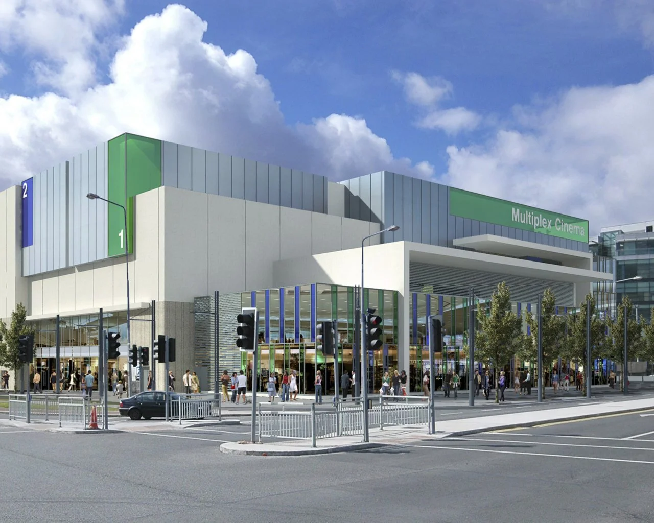 Modern multiplex cinema building with people waiting outside and traffic signals in the foreground.