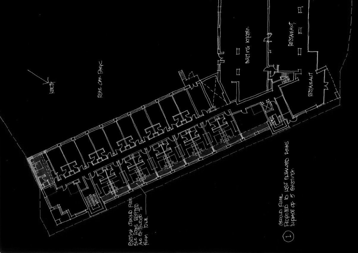 Architectural blueprint of a building with multiple rooms, including a lobby, bedrooms, bathrooms, and dining areas, with handwritten labels and notes.