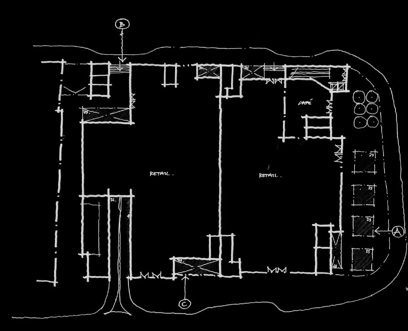Floor plan sketch of a commercial building with labeled retail spaces, entry points, and designated areas for stairs and storage, drawn in white on a black background.