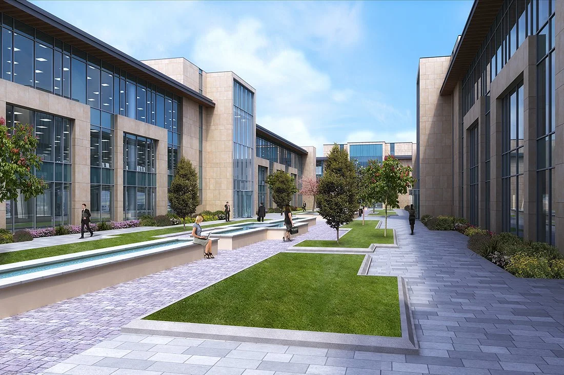 Modern office building courtyard with trees, benches, and walking paths under a blue sky.