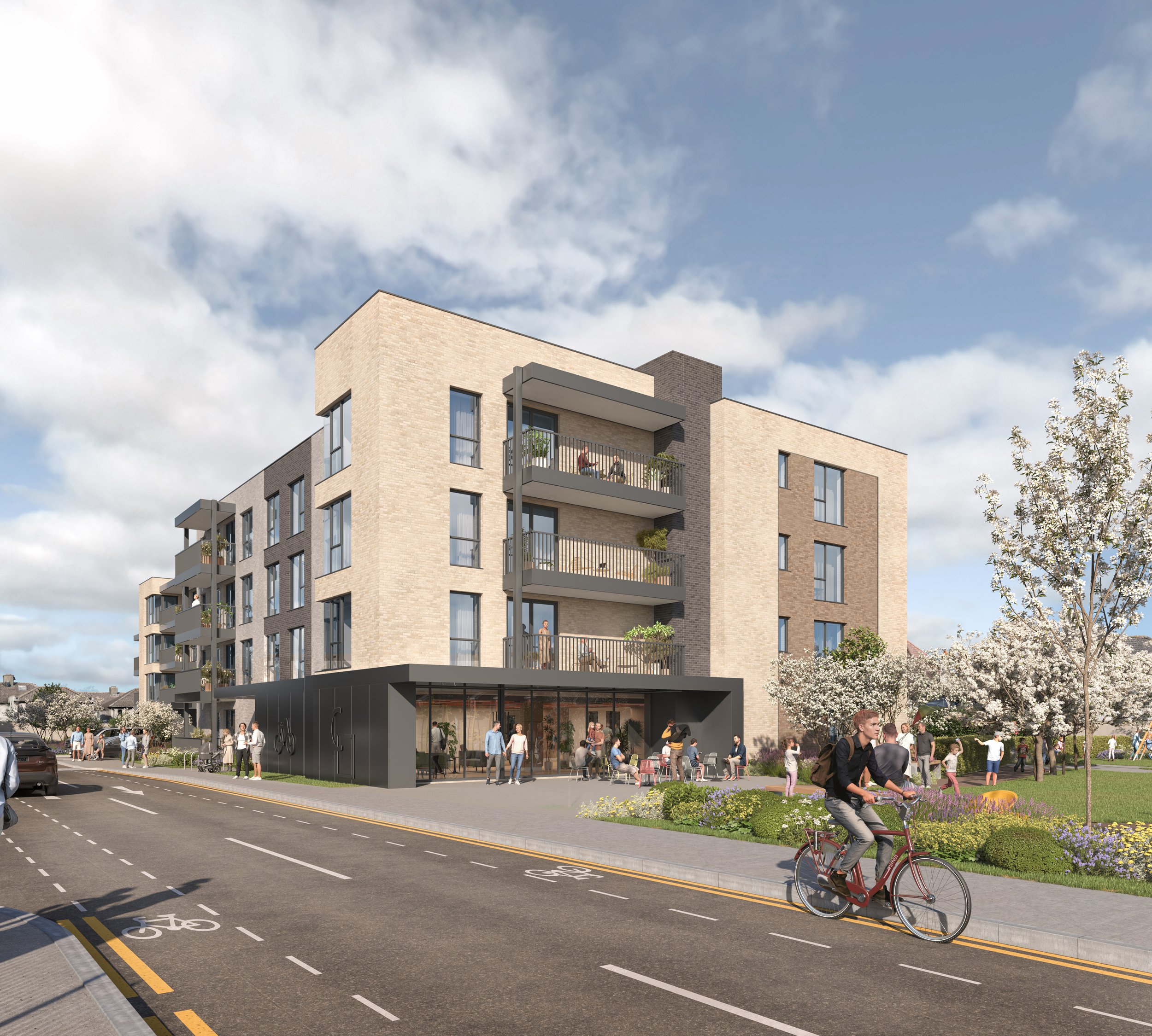 Modern multi-story apartment building with balconies and retail space on the ground floor, surrounded by outdoor seating, people walking, biking, and flowering trees under a partly cloudy sky.