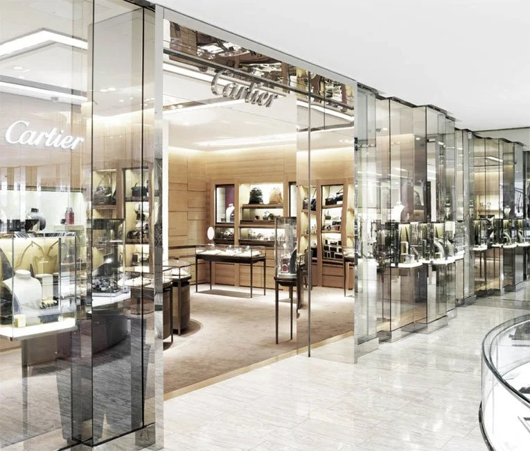 Jewelry store display with glass cases showcasing luxury jewelry inside a shopping mall.