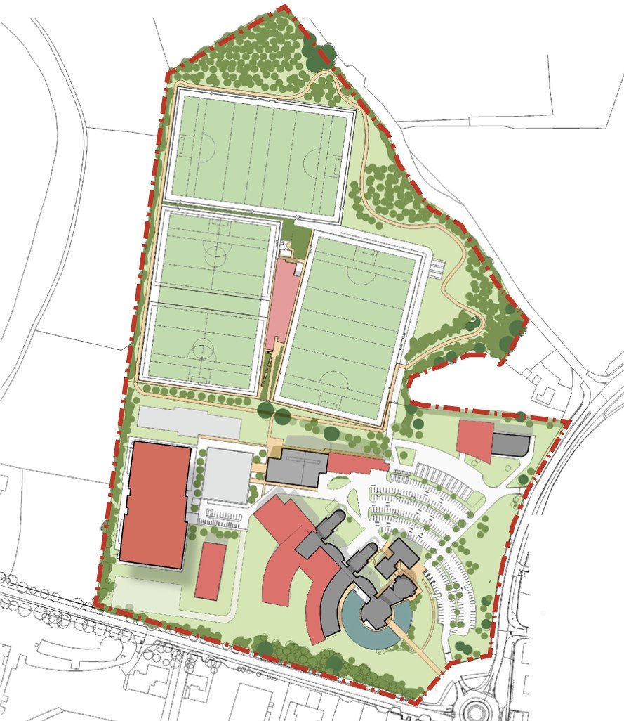 A detailed masterplan showing multiple sports fields, a walking trail, several buildings, parking lot, and landscaped areas within a boundary marked by a red dotted line.