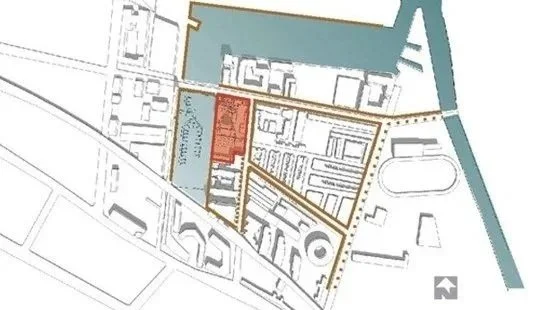 A map showing a layout of buildings, roads, and waterways with a red-highlighted building.