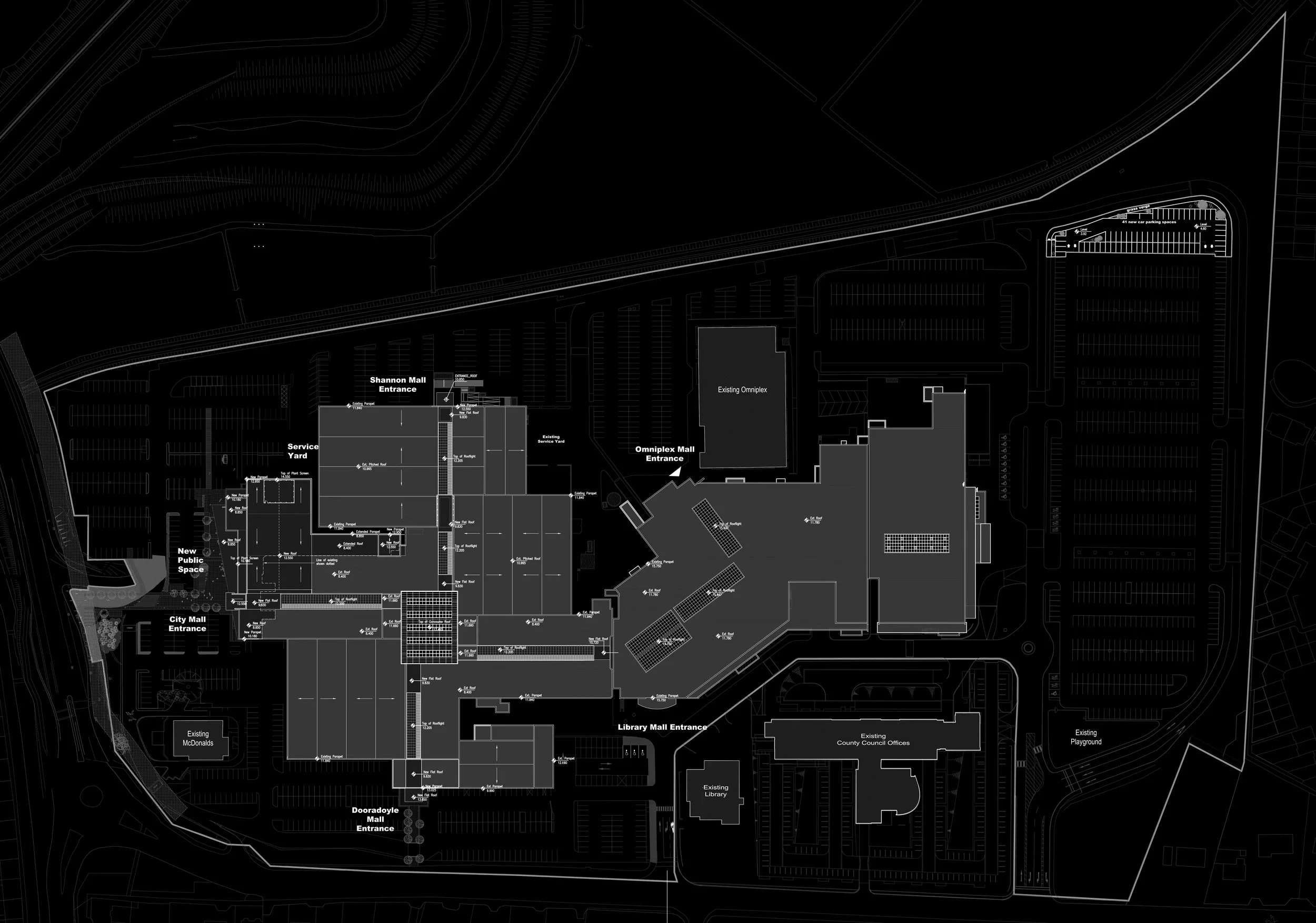A detailed black and white architectural blueprint of a large shopping mall complex, including entrances, parking lots, service areas, and surrounding structures.