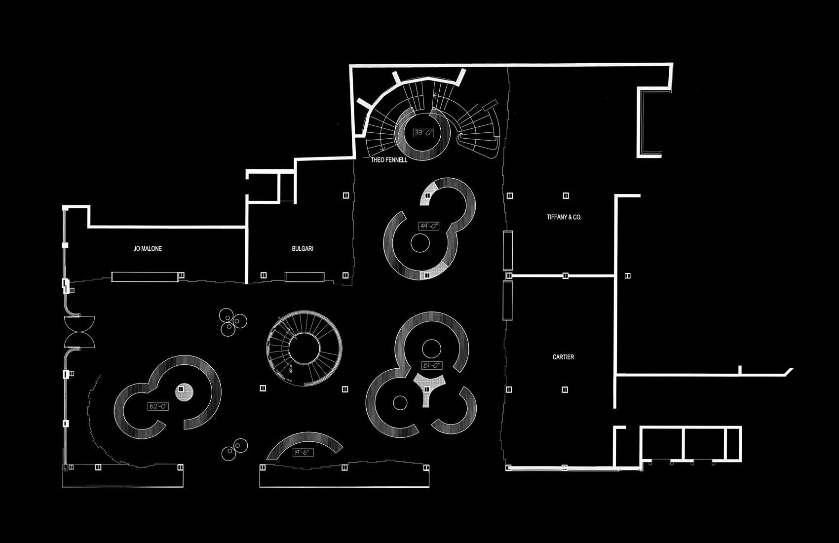 Floor plan of a luxury jewelry store with sections labeled Jo Malone, Bulgari, Tiffany & Co., Cartier, and Theo Fennell. Contains circular display areas and an entrance on the left side.