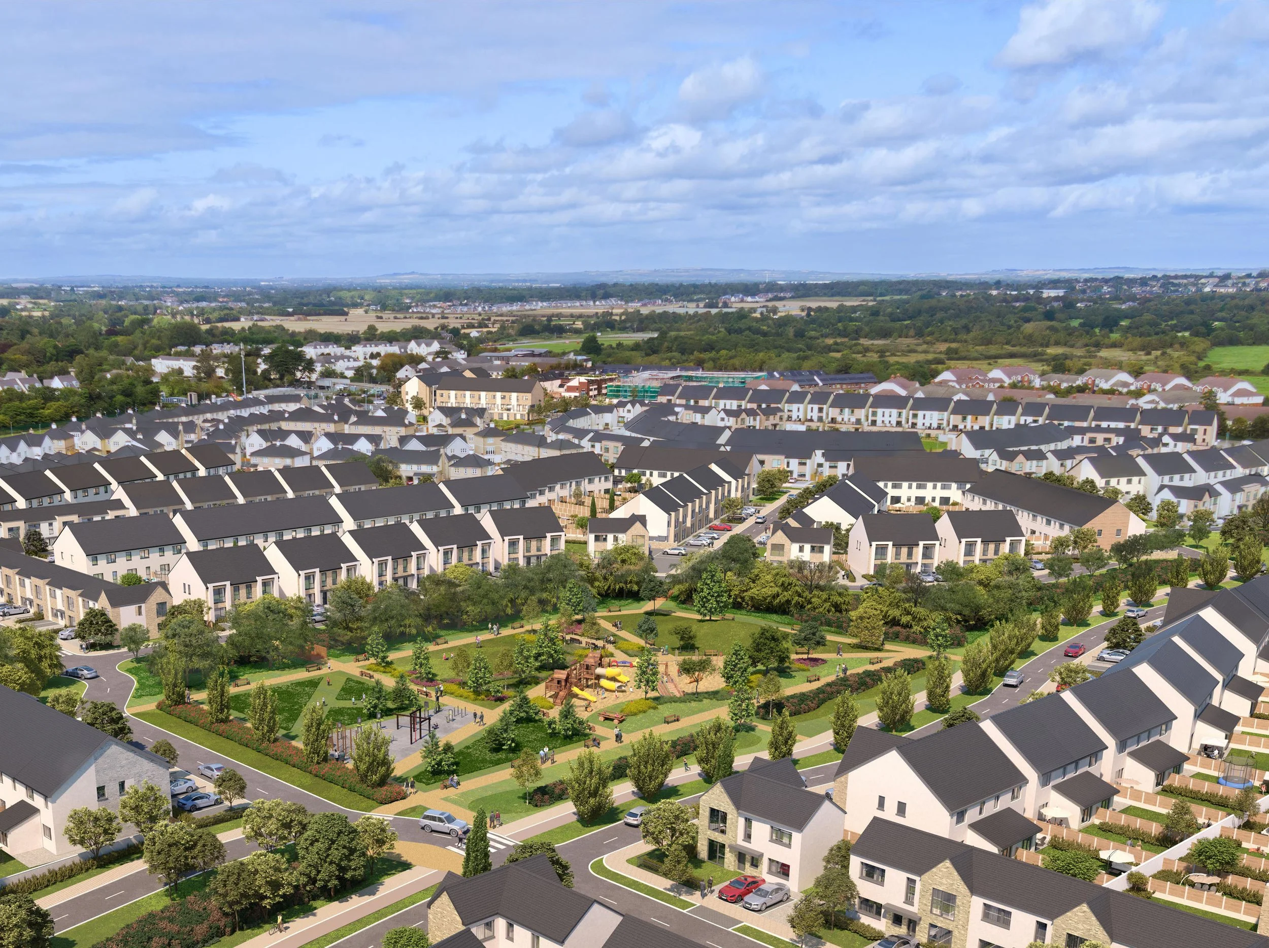 Aerial view of a suburban neighborhood with modern houses, a central green park with playground equipment, trees, walkways, and cars parked along the streets under a partly cloudy sky.