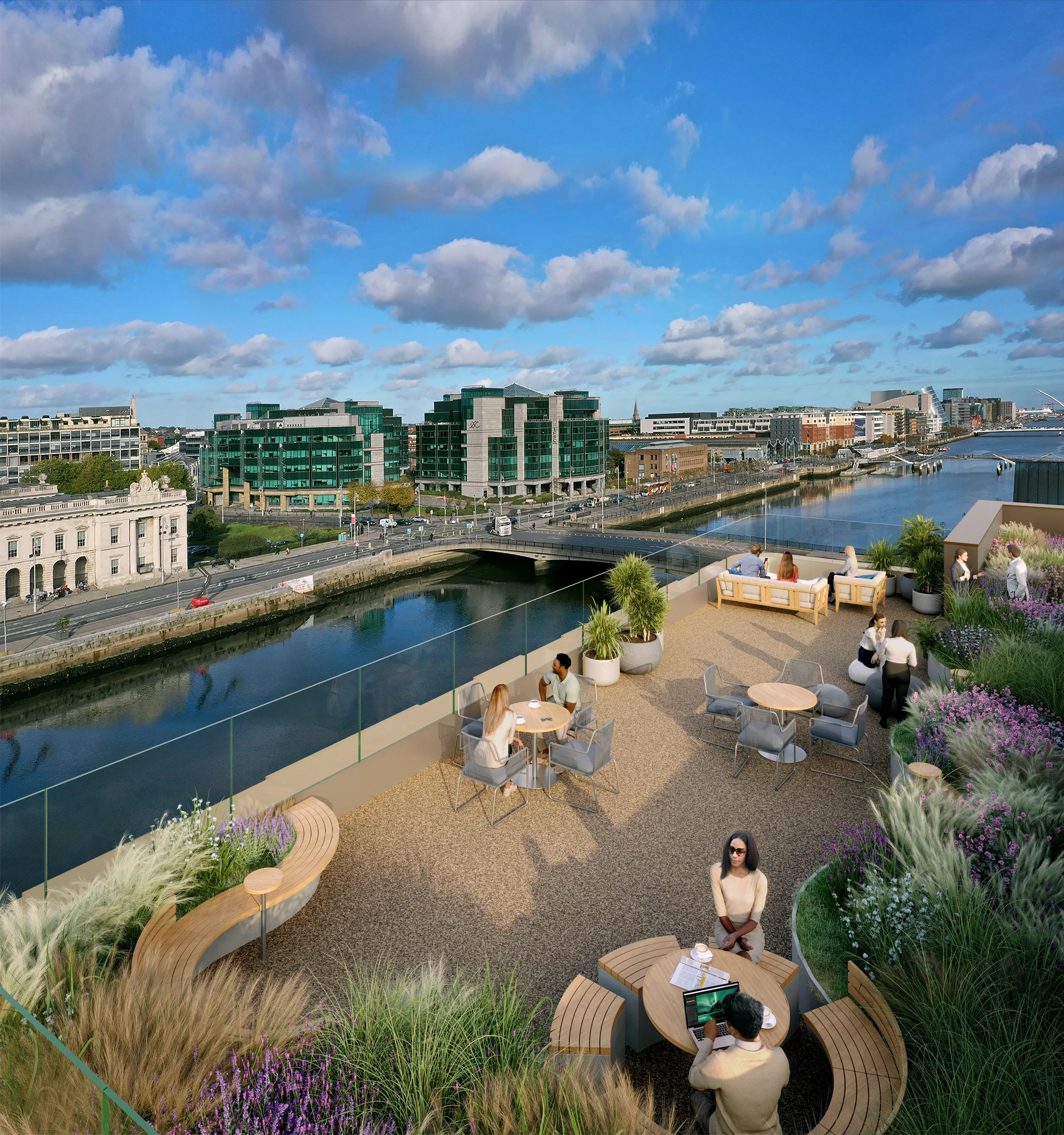 Rooftop terrace with people sitting at tables and on sofas overlooking a river and cityscape with modern buildings, a bridge, and a partly cloudy sky.
