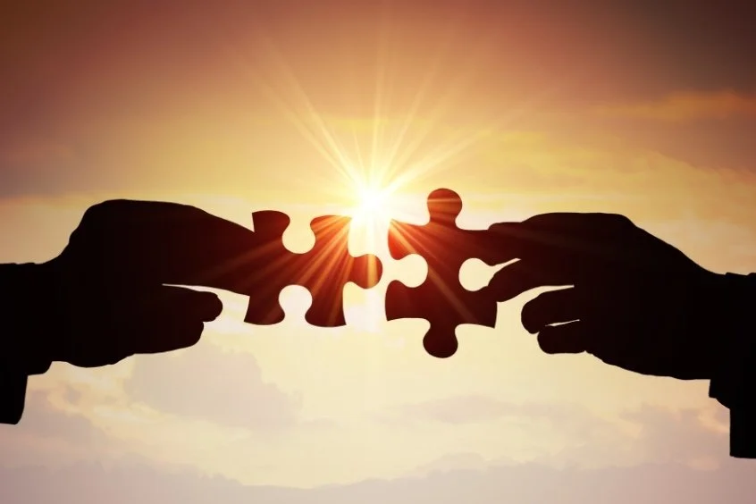 Two Nonprofit leaders with two puzzle pieces.