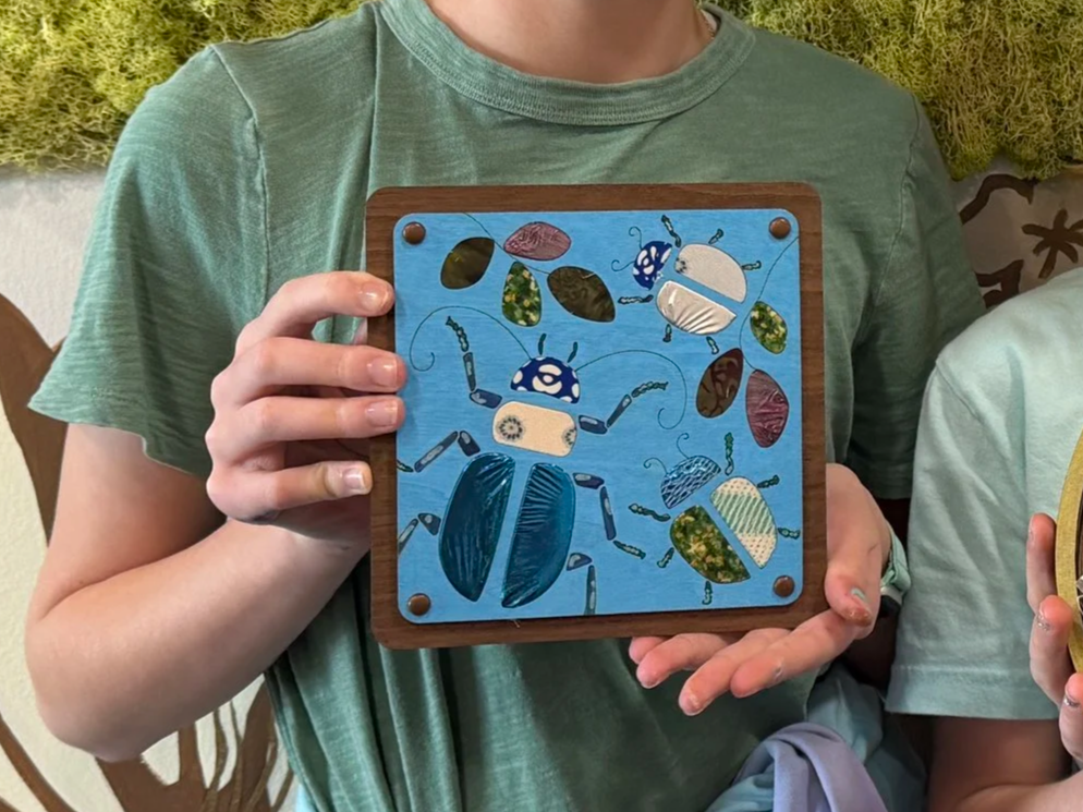 Twelve year old holding a crafted Fiber Art creation at Creative Array.