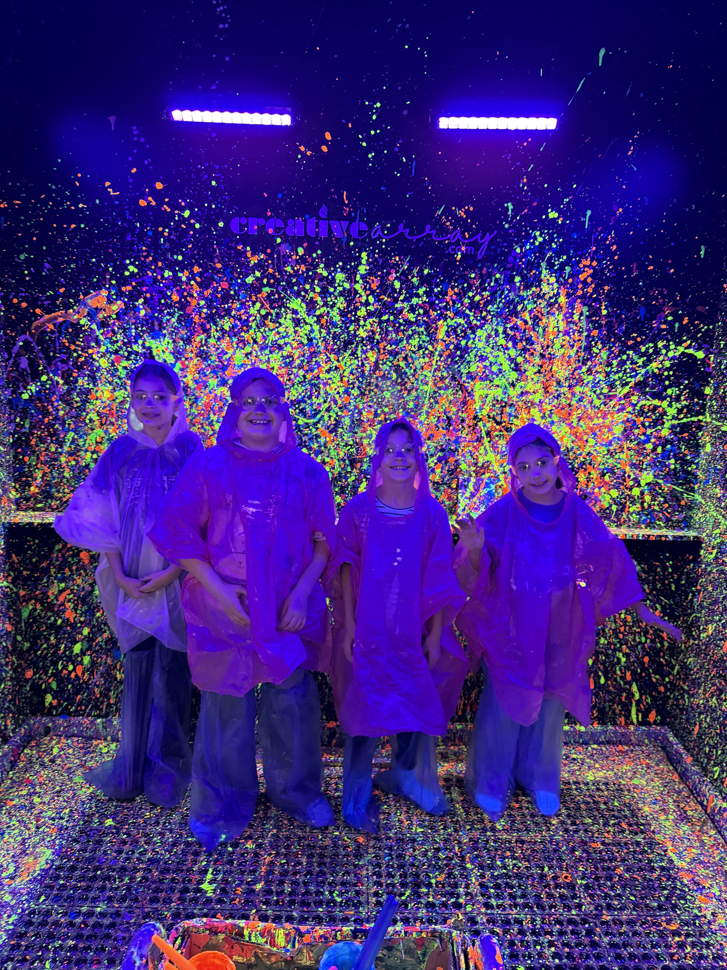 Small group making splatter paintings.