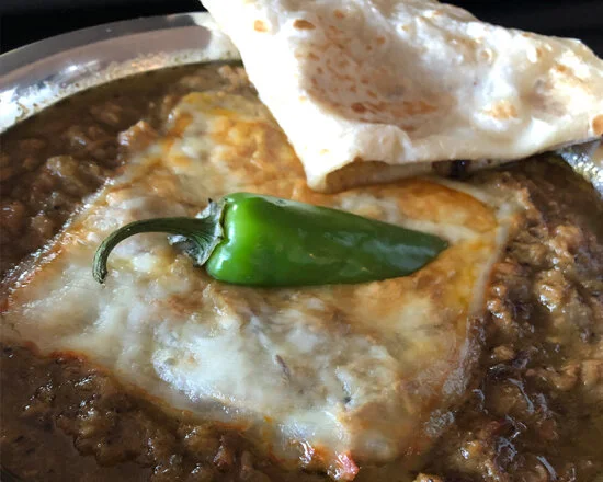 Hatch Green Chile Stew with melty cheese and fresh tortillas