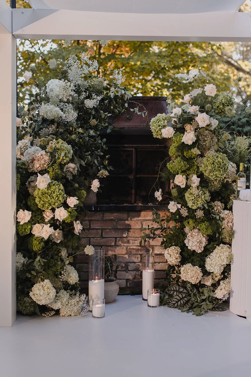 "Romantic fireplace wedding backdrop with hydrangeas and roses in Toronto"