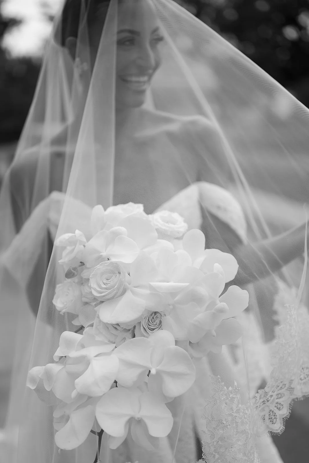 "Classical cascading orchid bridal bouquet with a modern romantic design, featuring luxury white blooms and soft movement by a Toronto, Niagara, and Cambridge florist"