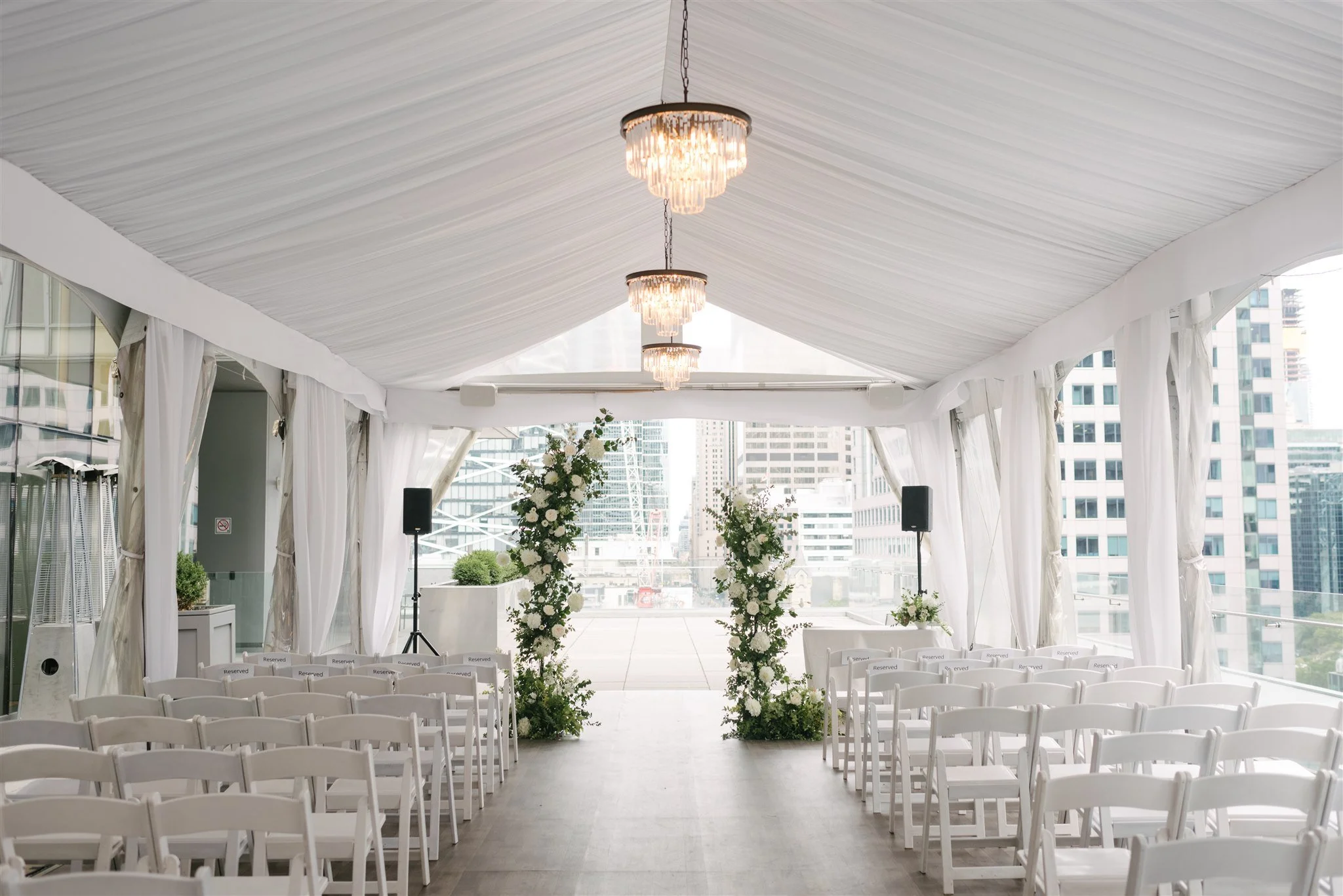 "Bold floral arch installation with vibrant flowers for a luxury outdoor wedding by a Toronto florist