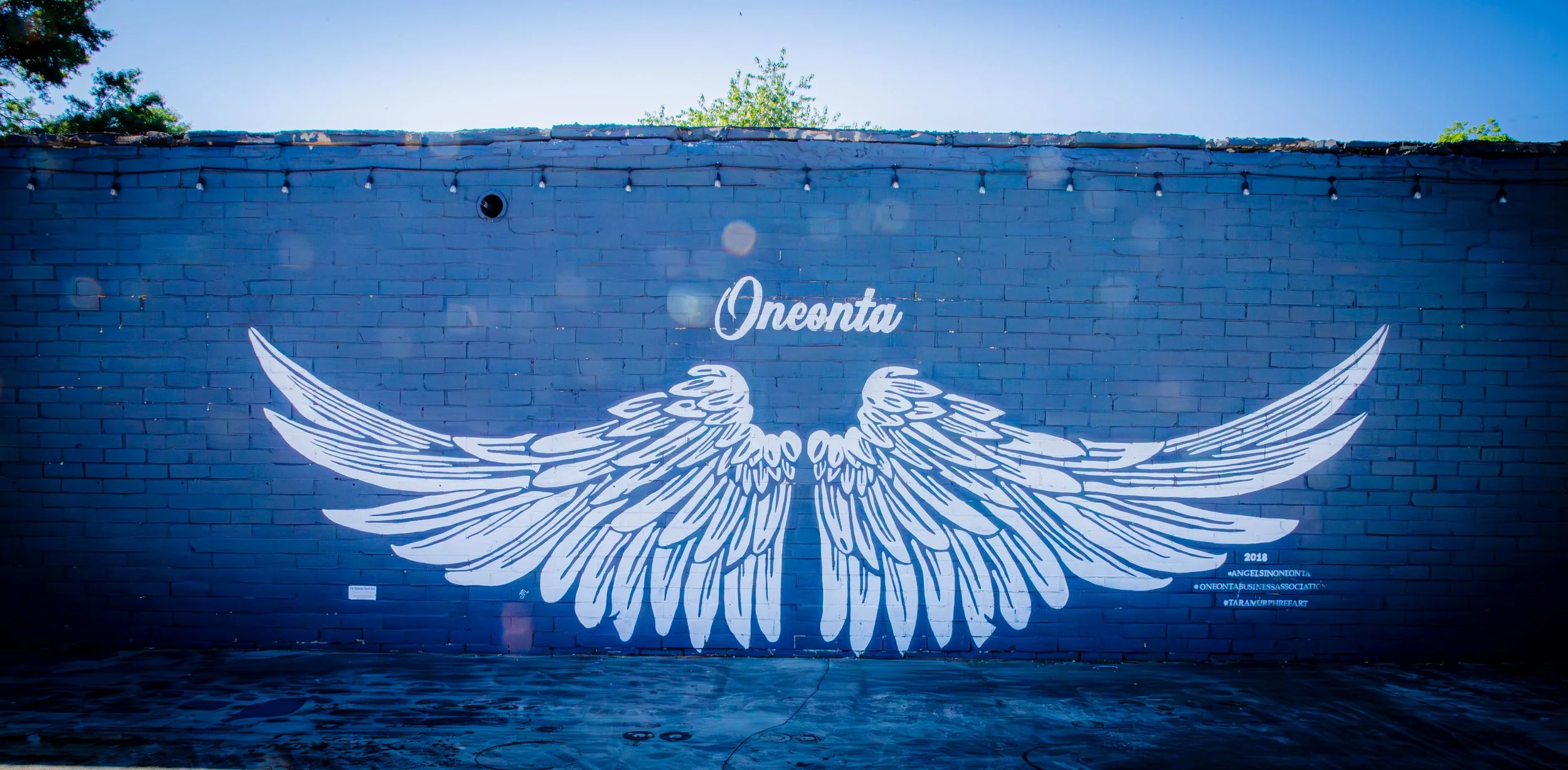 Mural of large white angel wings in downtown Oneonta, AL.