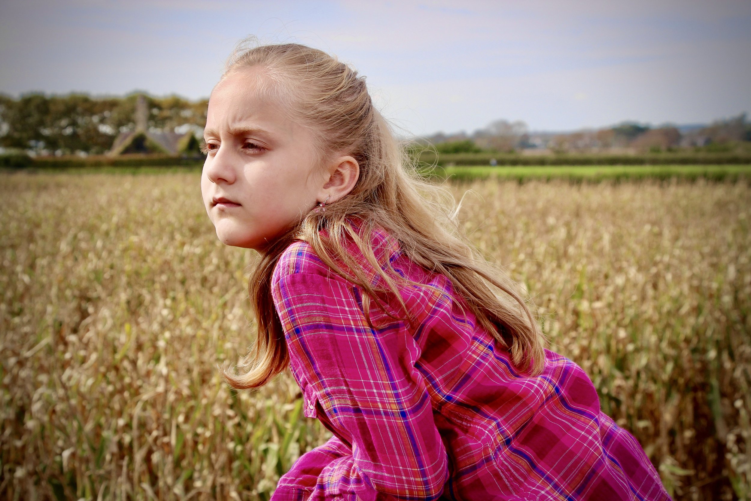 A candid portrait capturing quiet presence in a golden field, reflecting Sean Broedow's philosophy on attention and stillness