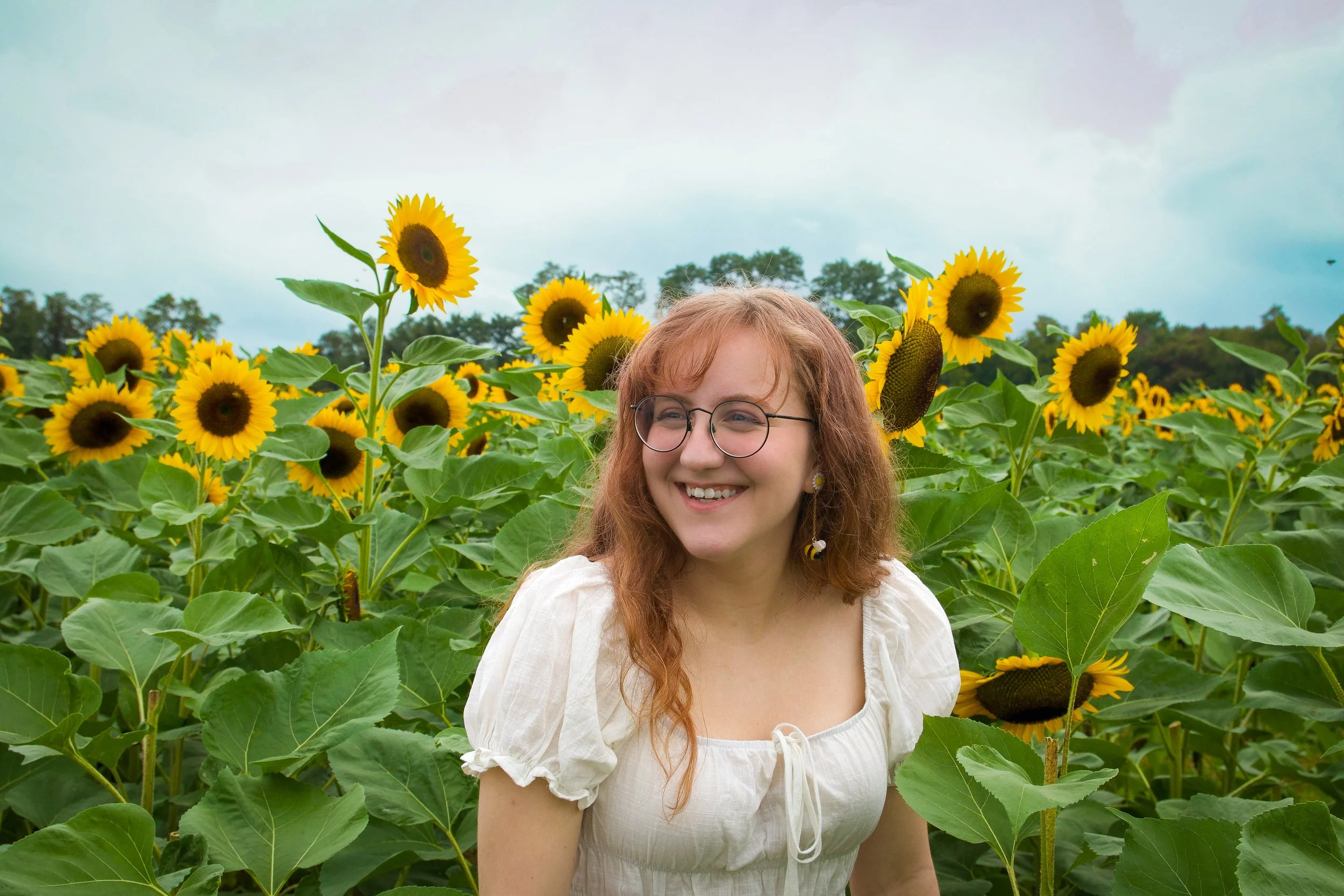 Authentic outdoor portrait of a woman in sunflowers by NYC photographer Sean Broedow