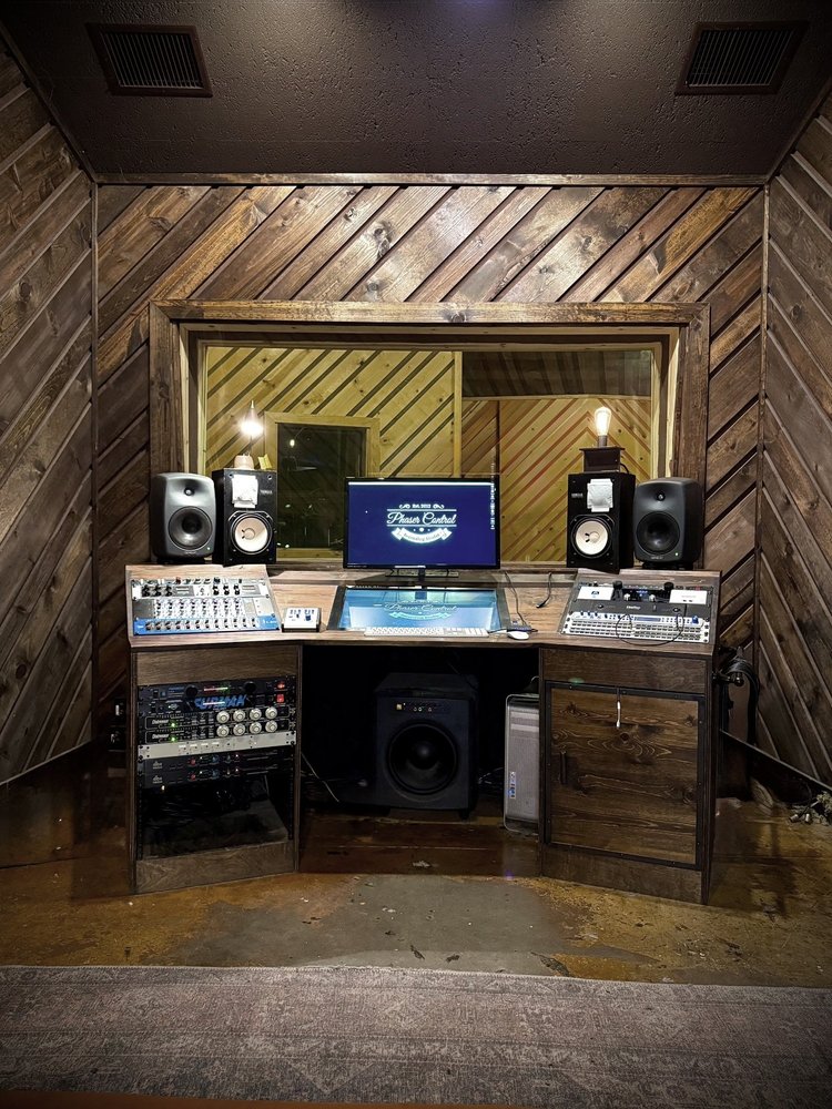 The control room seen from the doorway, monitors and desk ahead.