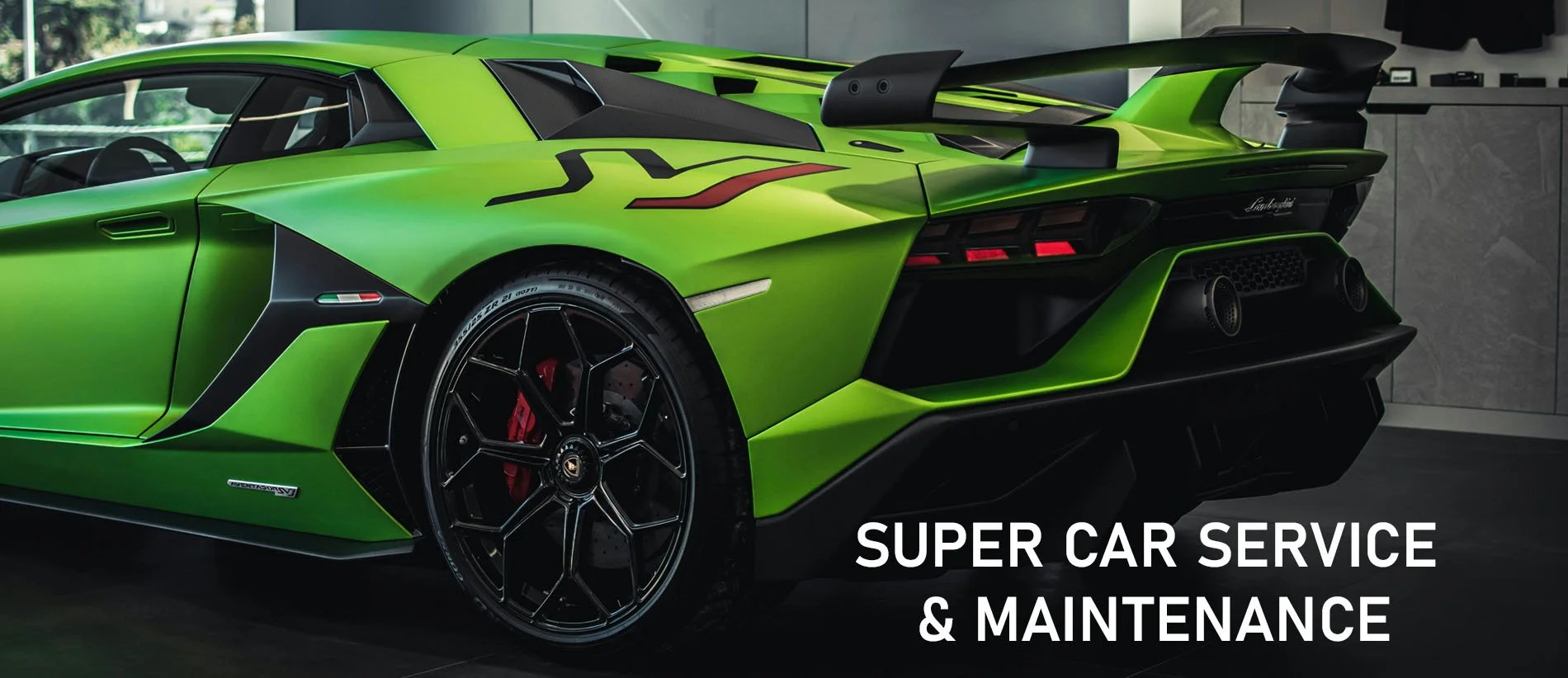 Green Lamborghini sports car parked indoors with a slogan reading 'Super Car Service & Maintenance' in white text over the lower right corner.