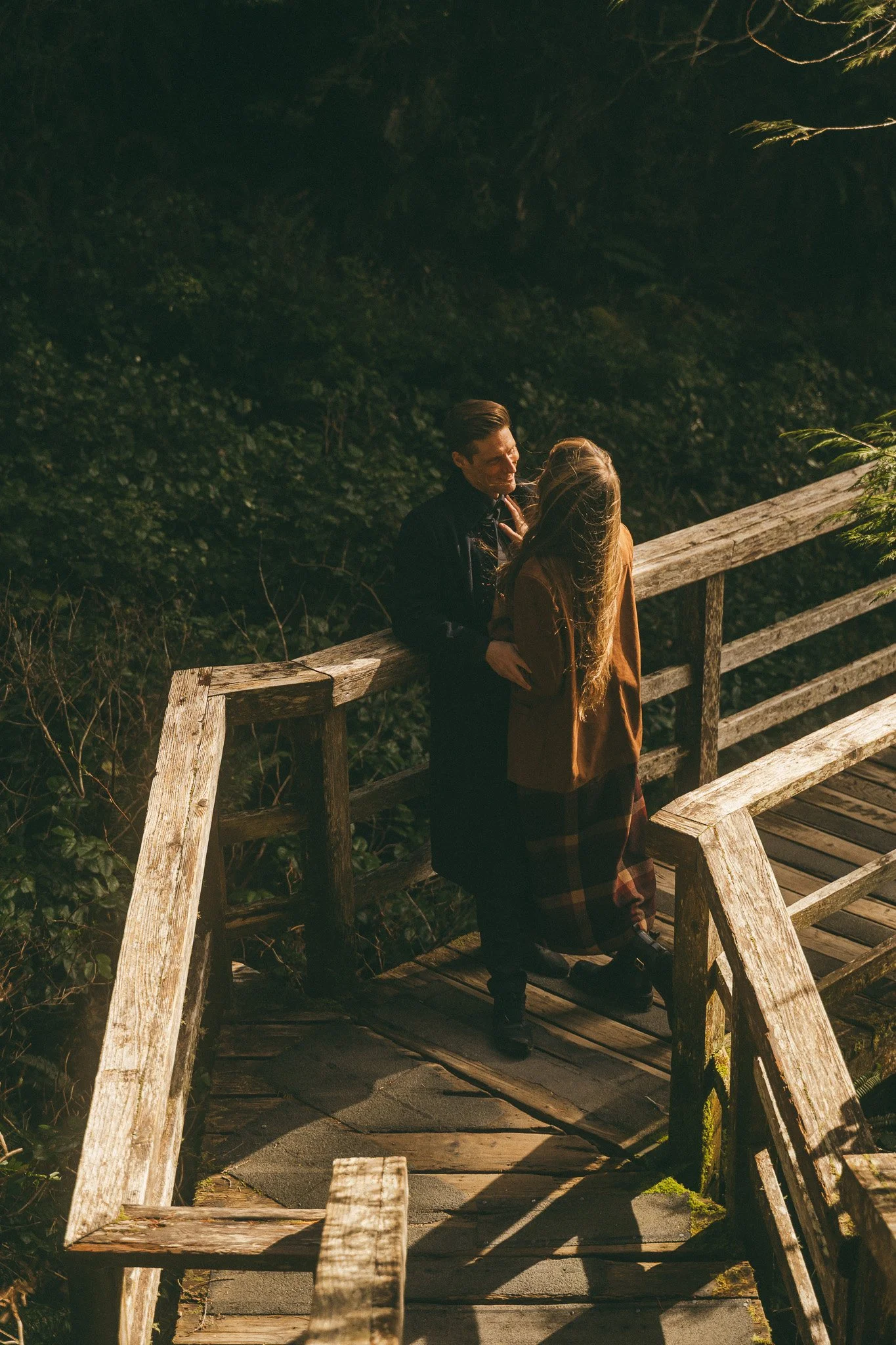 Adventurous couples session in a forest in Tofino, Vancouver Island, featuring golden-hour light and natural storytelling photography.