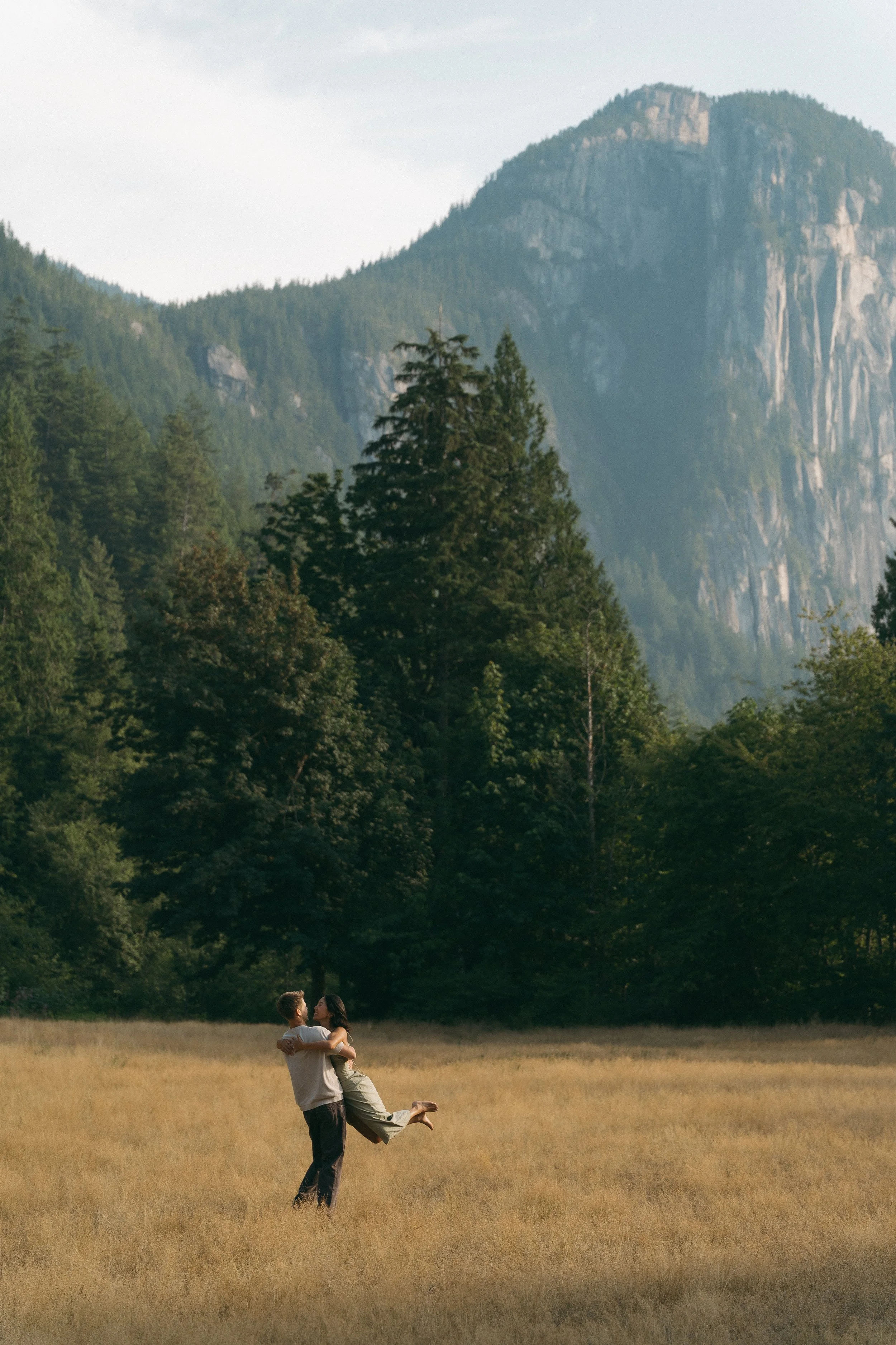 couples golden hour engagement session in the mountains and a field in Squamish BC