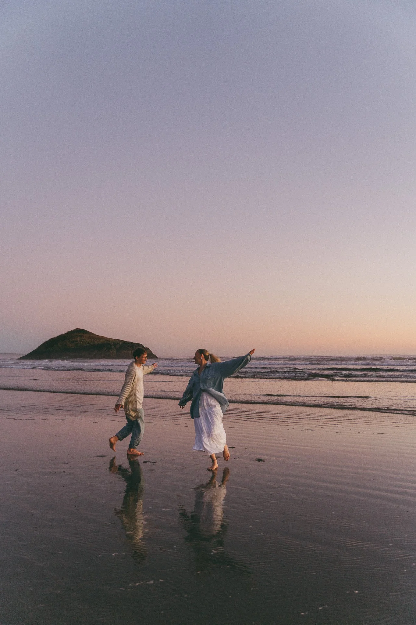 couple on beach in Tofino BC at sunset