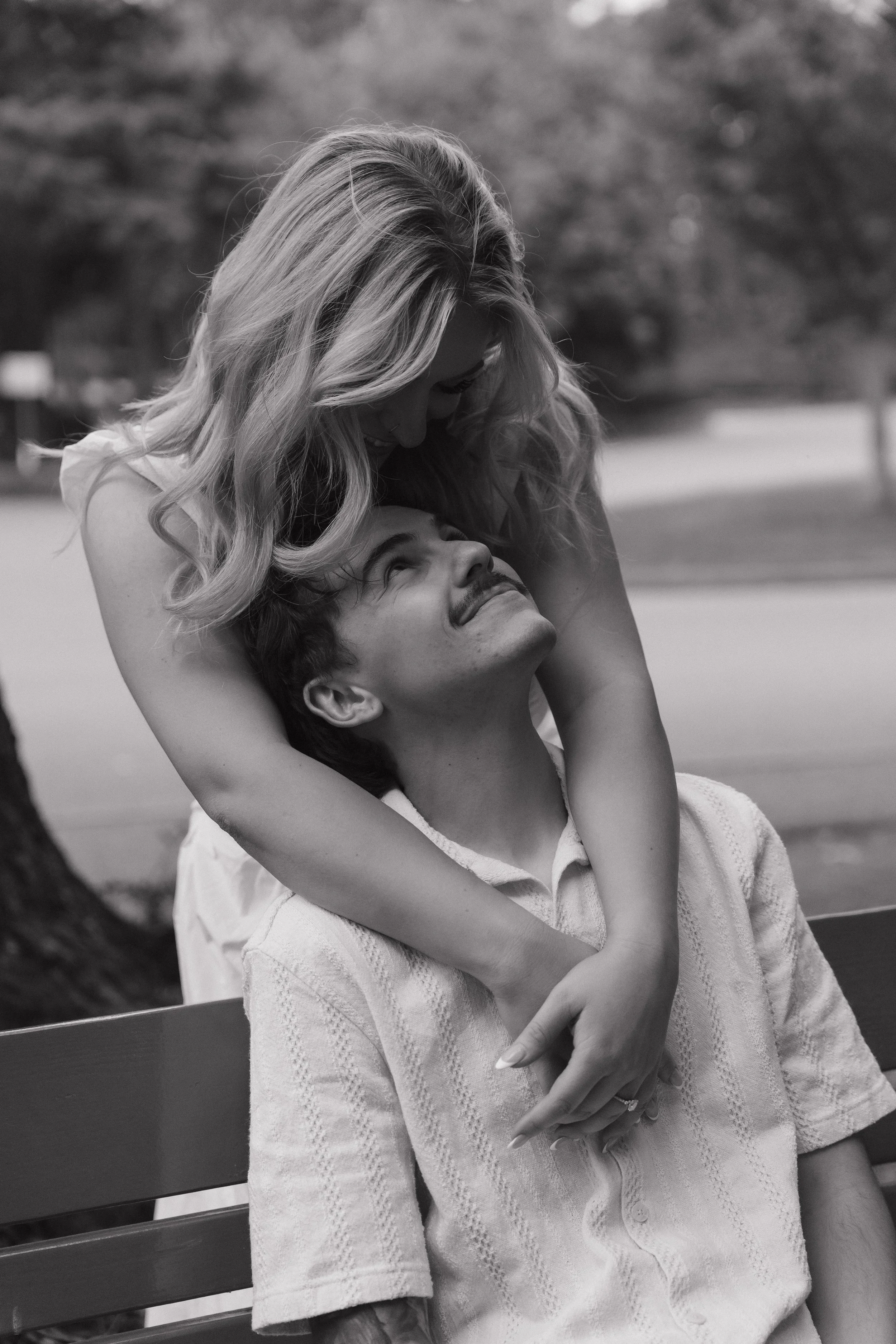 couple sitting on park bench, engagement session Victoria BC