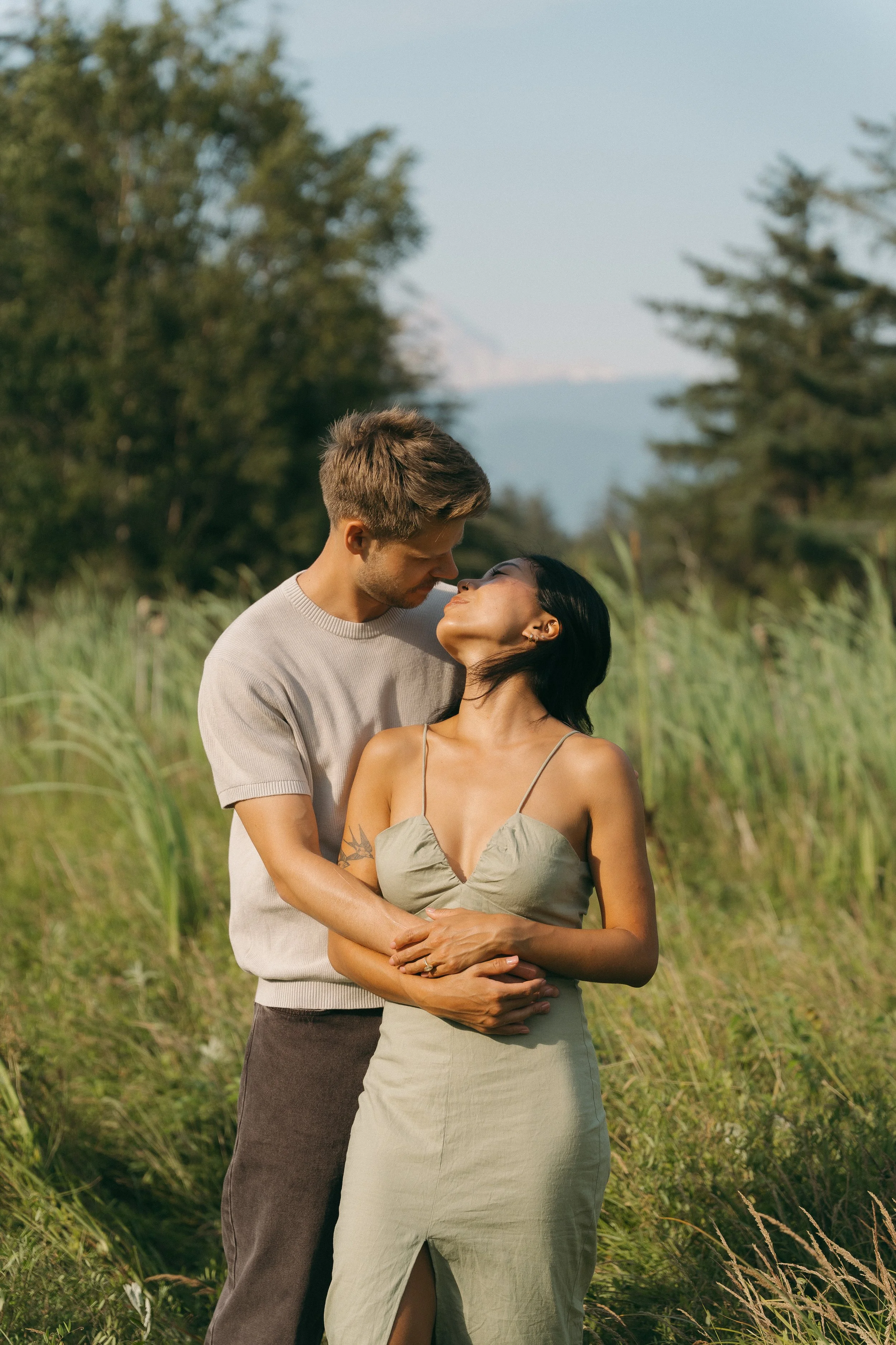 couples golden hour engagement session in a field in Squamish BC